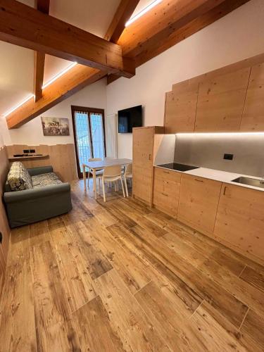 a kitchen with a couch and a table in a room at Residence Cima Tosa in Andalo