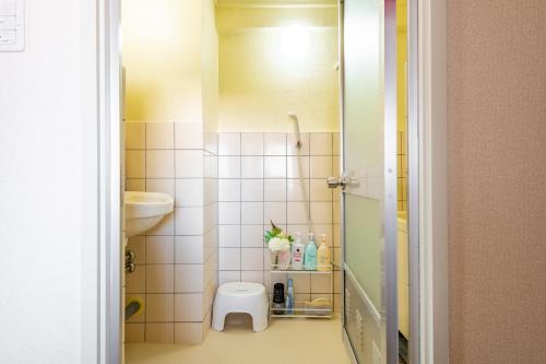 a small bathroom with a toilet and a sink at SakuraFlat in Tokyo