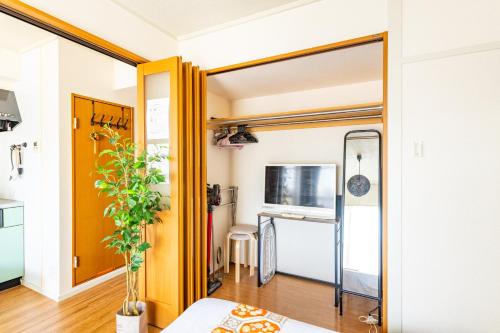 a living room with a sliding door and a table at SakuraFlat in Tokyo
