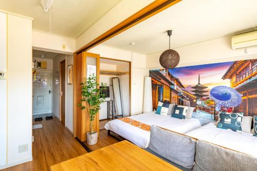 a bedroom with two beds and a couch at SakuraFlat in Tokyo