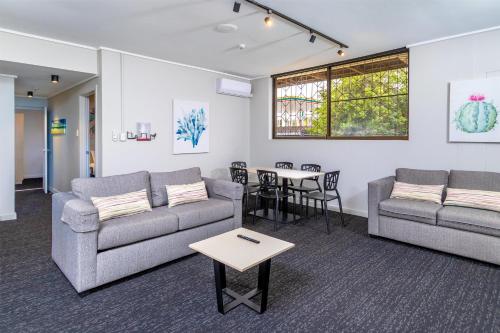 a living room with two couches and a table at Nightcap at Springwood Hotel in Springwood