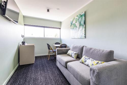 a living room with a couch and a table at Nightcap at Commercial Hotel in Gold Coast