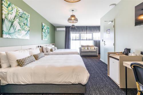 a bedroom with a large bed and a desk at Nightcap at Commercial Hotel in Gold Coast