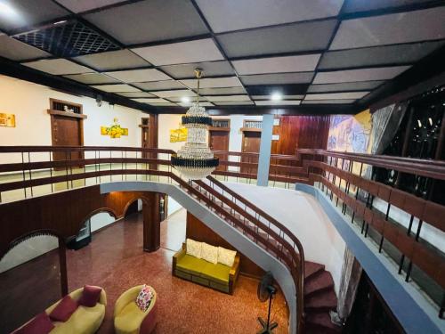 a balcony of a cruise ship with a bed and chairs at Humming Birds Suites in Jaffna
