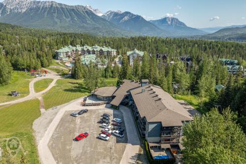 an aerial view of a resort with cars parked in a parking lot at Griz Inn by StayIn in Fernie
