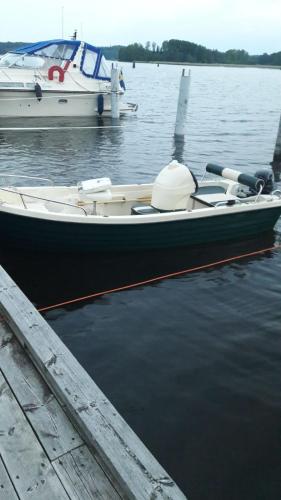 a boat is docked at a dock in the water at Naturparadies und Angleroase Borgvik in Borgvik