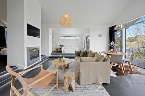 a living room with a couch and chairs and a fireplace at Hepburn Bathhouse & Spa Villas in Hepburn Springs