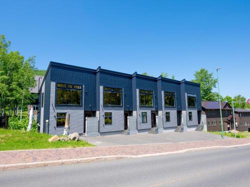 a blue building on the side of a street at Minn house Niseko Hirafu in Kutchan