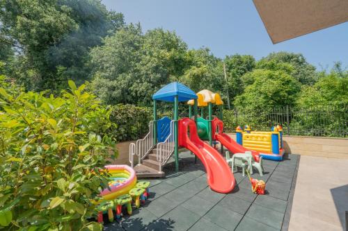 a playground with a slide and a play set at Aqua View SPA Boutique Hotel in Golden Sands