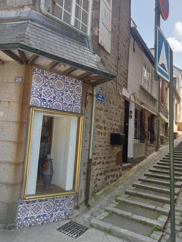 a building with a window on a street at L'Écrin Appart in Villedieu-les-Poëles