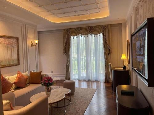 a living room with a couch and a table at Golden Sun Hotel - Dalat in Da Lat