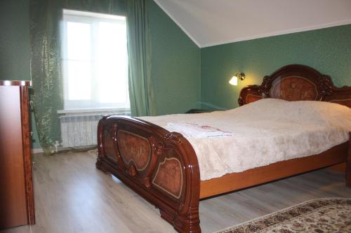 a bed in a green bedroom with a window at Apartments Galactika in Oral