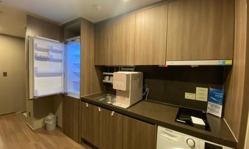 a kitchen with a sink and a microwave at D OV Haeundae Hotel in Busan
