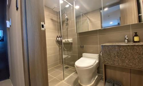 a bathroom with a shower and a toilet and a sink at D OV Haeundae Hotel in Busan