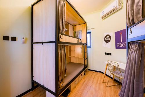 a large cabinet in a room with a bed at BeiJing Seeyou Hostel -Close to the city center Near Subway Line 10 Sanyuanqiao,Close to Sanlitun,Yonghe Lama Temple,Tourism service in Beijing