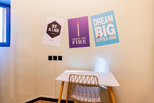 a room with a table and posters on the wall at BeiJing Seeyou Hostel -Close to the city center Near Subway Line 10 Sanyuanqiao,Close to Sanlitun,Yonghe Lama Temple,Tourism service in Beijing