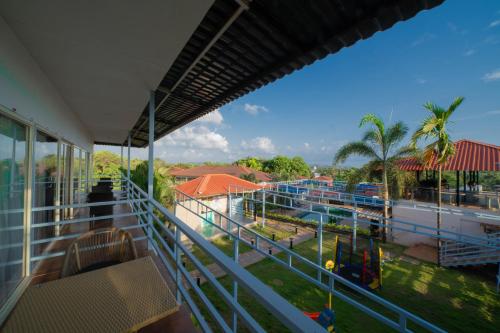 a balcony with a view of a amusement park at Koko Maya by Perfectstayz near Morjim Beach in Morjim