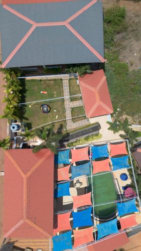 an overhead view of a building with a swimming pool at Koko Maya by Perfectstayz near Morjim Beach in Morjim