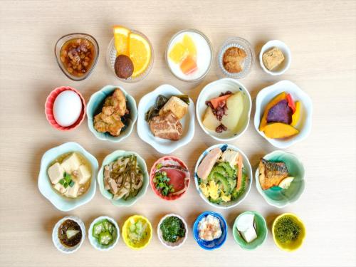 a group of bowls filled with different types of food at Hotel Risingsun Miyakojima in Miyako Island