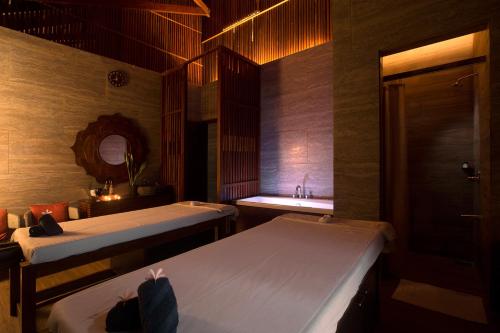 a room with two beds and a sink in it at Sea Shell Resort & Spa, Havelock in Havelock Island