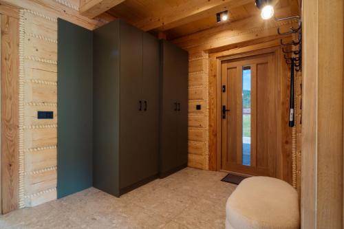 a hallway with a door and a chair in a house at Domki Na Wspólnej in Wisła