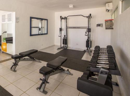 a room with a gym with tread machines at Hotel Villa Taina in Cabarete