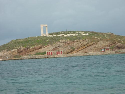 a lighthouse on top of an island in the water at Joanna Apartments in Mikri Vigla