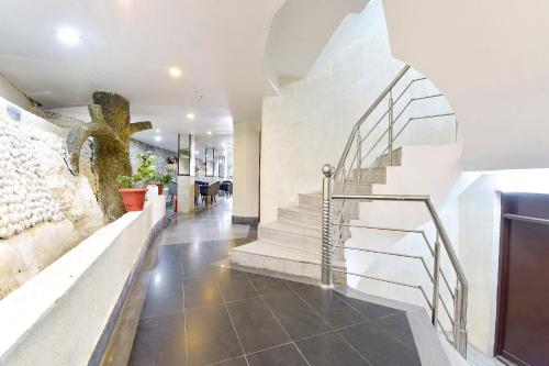a hallway with stairs in a house at FabHotel Sikka Royal Classic - Mall road in Mussoorie