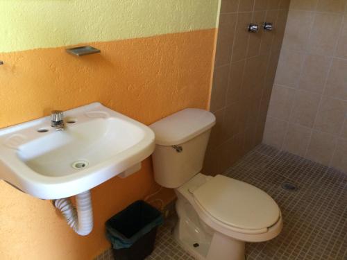a bathroom with a sink and a toilet at Hotel Las Salinas in Zihuatanejo