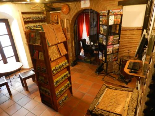 a room with a shelf of wine bottles at Posada La Casa Grande in Jimena de la Frontera