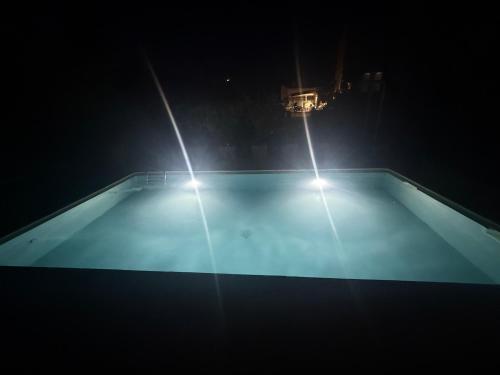 two lights on top of a swimming pool at night at Le Clos d'Aix studio 102 parking in Aix-en-Provence