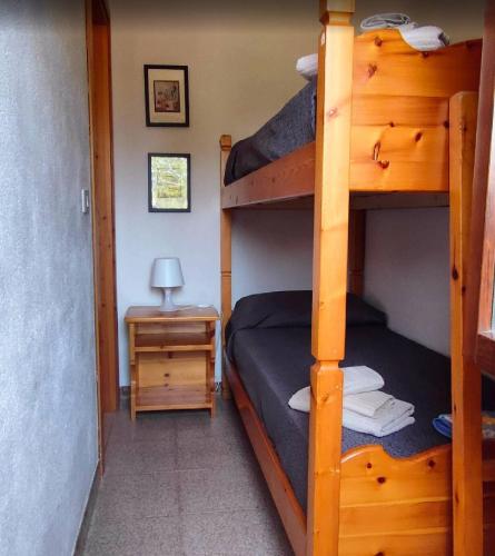 a bedroom with two bunk beds and a night stand at Bouganville in Costa Rei