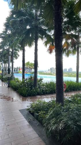 a park with palm trees and a body of water at Iskandar Sunway Grid X Park Walking distance to Bigbox Legoland in Nusajaya