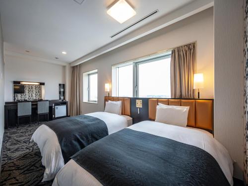 Postel nebo postele na pokoji v ubytování APA Hotel Shonan Tsujido Ekimae