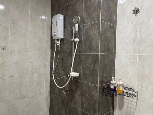a shower with a shower head in a bathroom at Le Cozy Home UKM BANGI KAJANG BACC GMI UIS in Bangi