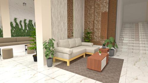 a living room with a couch and a coffee table at Garuda Hotel By Calandra in Banda Aceh