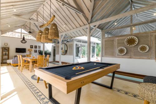 a pool table in the middle of a living room at Villa Cemacase - Stylish 2BR Villa with Spacious Private Pool & Pool Table in Seseh in Cemagi