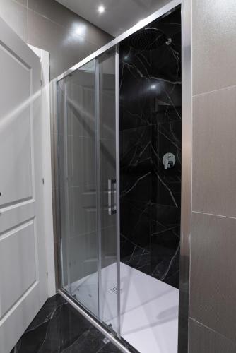 a shower with a glass door in a bathroom at Maison Rasella Palace Suites in Rome