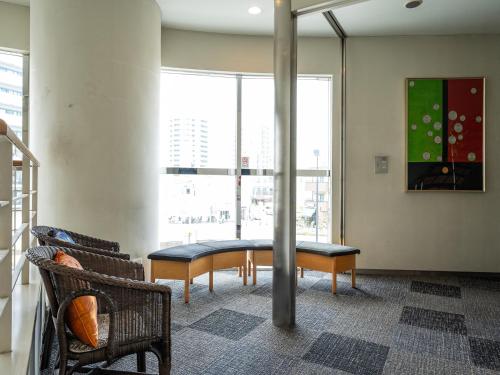 a room with a table and two chairs and a large window at APA Hotel Shonan Tsujido Ekimae in Fujisawa