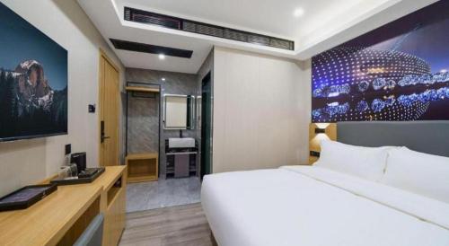 Cama o camas de una habitación en Sheng Lin Na Hotel Minzhi Branch