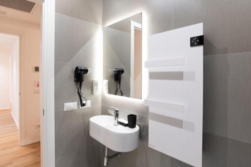 a bathroom with a sink and a mirror at Maison Rasella Palace Suites in Rome