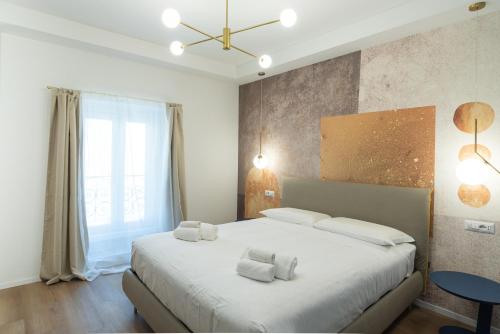 a bedroom with a large bed with white pillows at Maison Rasella Palace Suites in Rome