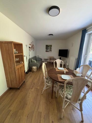 a living room with a wooden table and chairs at Pina's Appartment in Namur