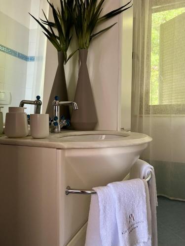 a bathroom with a sink and a toilet with towels at ARTs at the Old Town in Grottammare