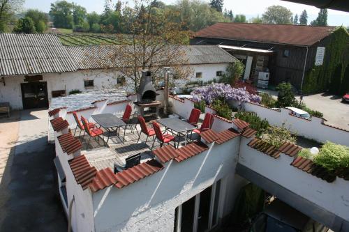 an outdoor patio with chairs and a grill on a building at Ferienhof Schöngarten in Lindau