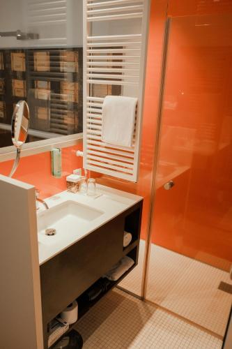 a bathroom with a sink and a shower at arte Hotel Linz in Linz