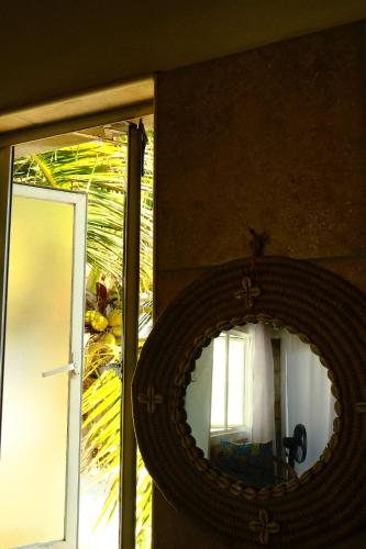 a mirror on a wall next to a door at Lehani Beach Hostel in Praia do Tofo
