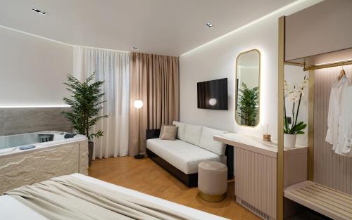 a hotel room with a bed and a bathroom at Aeolian Spirit Suites in Athens