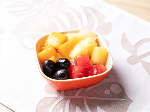 an orange bowl filled with fruit on a table at Comfort Hotel Ishigaki Island in Ishigaki Island