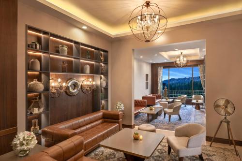 a living room with a couch and chairs at The Khyber Himalayan Resort & Spa in Gulmarg
